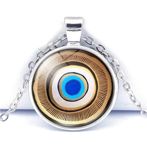 Detail of blue evil eye glass pendant necklace with metallic chain and exotic pattern
