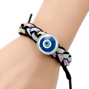 Detailed close-up of handmade woven rope bracelet featuring a blue evil eye glass charm
