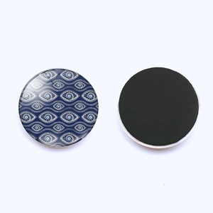 Detail showing the Evil Eye crystal glass fridge magnet and its black magnetic back