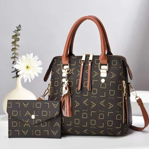Detail of monogram large tote bag and matching long wallet with cat pendant decoration