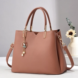 Elegant bean paste brown leather tote bag with gold rabbit pendant and detachable strap