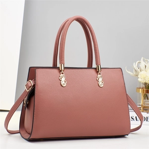 Dusty rose macaron handbag in textured leather with gold hardware and top handles