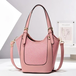 Pink patchwork bucket bag with weaving texture and golden metal hardware details