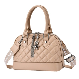 Beige quilted diamond shell handbag with stylish patterned wide strap and charm