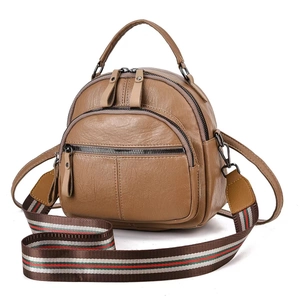 Brown soft leather backpack featuring a stylish red and green striped woven shoulder strap
