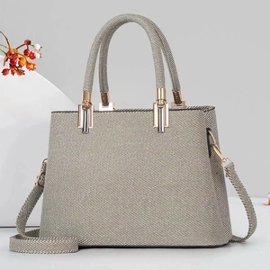 Elegant woven multi-layer tote bag in beige and grey with gold hardware and shoulder strap