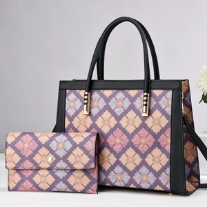 Detail of floral tote and wallet set with purple floral pattern and gold hardware