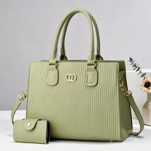 Detail of light green striped tote bag with gold ring hardware and matching wallet set
