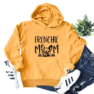 Flat lay of mustard Frenchie Mom hoodie with dog print, jeans and sneakers