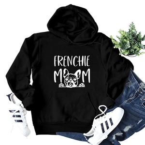 Flat lay of Frenchie Mom black hoodie with a dog drawing and casual outfit accessories