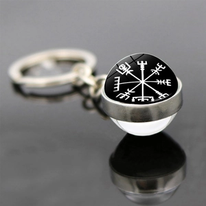 Close-up of Viking compass Vegvisir symbol in a double-sided glass ball keychain