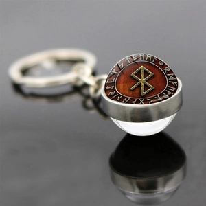 Nordic Viking compass keychain with Odin rune symbol glass ball on reflective surface