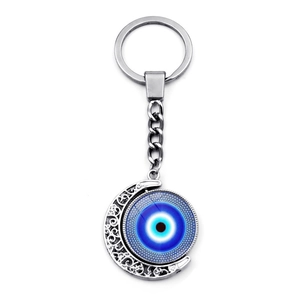 Llavero plateado con luna giratoria y colgante de ojo turco azul protector