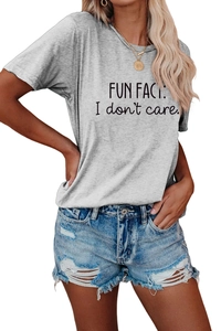 Close-up of light grey cotton T-shirt with Fun Fact slogan and ripped denim shorts