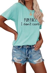 Detail of light blue t-shirt with 'FUN FACT: I don't care' print and ripped denim shorts