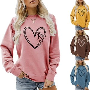 Detail view of long sleeve crewneck sweatshirts in pink, yellow, brown and blue with math heart print