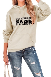 Detail view of beige hoodie with Life Is Better On The Farm slogan and front pocket