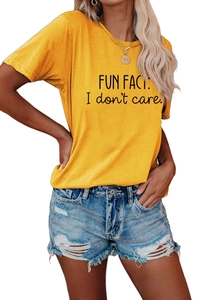 Close-up of yellow graphic T-shirt with Fun Fact I Don't Care slogan and denim shorts