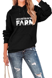 Detail view of the black farm slogan hoodie featuring high-quality white graphic printing
