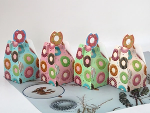 Set of colorful donut-themed pastry gift boxes with unique bitten-donut shaped handles