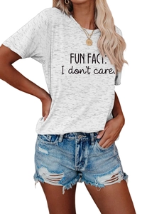Close-up of Fun Fact I Don't Care slogan t-shirt paired with distressed denim shorts