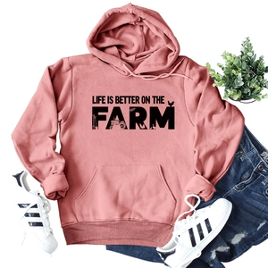 Detail of pink hoodie with Life Is Better On The Farm slogan and kangaroo pocket