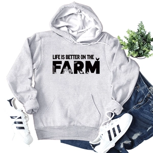 Flat lay of light grey hoodie featuring Life Is Better On The Farm slogan with front pocket