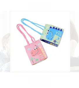Close-up of pink and green cartoon dinosaur paper gift bags with braided handles for parties