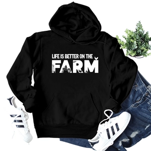 Detail of black drawstring hoodie with 'Life is better on the farm' graphic print