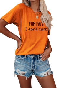 Detail of Fun Fact I Don't Care slogan print on an orange cotton crewneck t-shirt