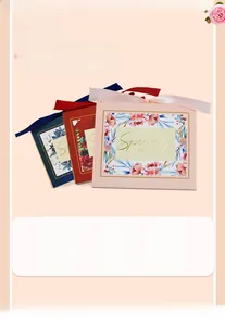 Detail of drawer gift boxes with ribbon bows and floral patterns in pink, red and blue