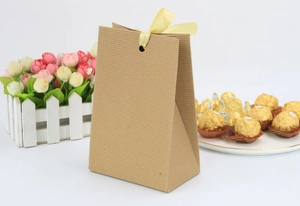 Detail of kraft paper Easter gift bag with striped texture and yellow silk ribbon bow