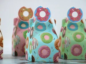 Detail showing donut theme gift boxes with creative bite-shaped handles and pastry patterns