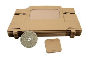 Flat lay of brown kraft cake boxes with windows, jute twine and square gift tags