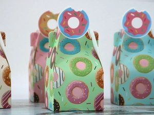 Macro shot of colorful donut-themed pastry gift boxes with unique cutout handles
