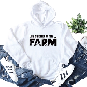 Flat lay of white hoodie with Life Is Better On The Farm text and farm icons
