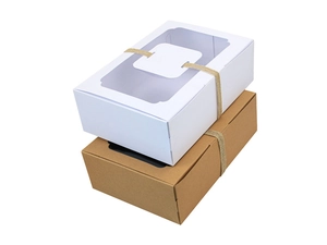 Detail of kraft and white paper gift boxes with transparent window and twine ribbon