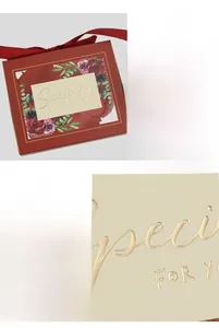 Macro detail of gold foil lettering and floral pattern on a dark red gift box