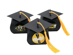 Detail of graduation cap gift boxes with yellow tassels and Congrats Grad stickers