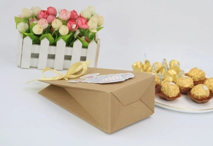 Detail of kraft paper Easter gift bag with yellow ribbon bow and cute bunny tag decoration