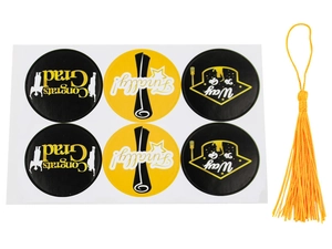 Close-up of graduation favor box accessories with Congrats Grad stickers and yellow tassel