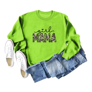 Flat lay of green Girl Mama sweatshirt with leopard print text and denim jeans