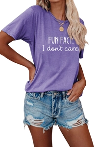 Close-up of purple crewneck T-shirt featuring FUN FACT: I don't care white printed text