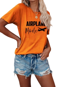 Détail du t-shirt orange avec imprimé AIRPLANE Mode et short en jean bleu délavé