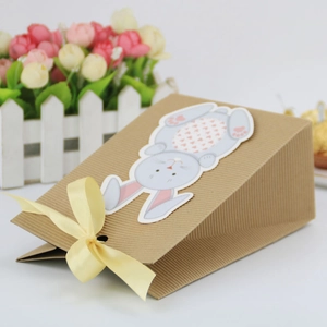 Easter bunny kraft paper gift bag with light blue rabbit pattern and yellow ribbon bow