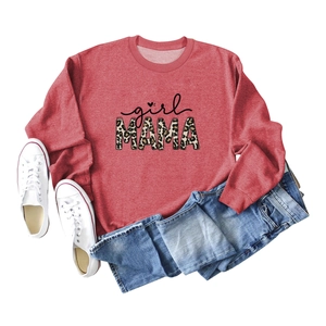 Flat lay of girl MAMA terracotta sweatshirt with leopard print text and denim shorts