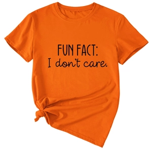 Detail of orange t-shirt with Fun Fact I Don't Care print and stylish side knot design