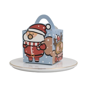 Scatola regalo di Natale blu con Babbo Natale e renne su piatto di porcellana bianca