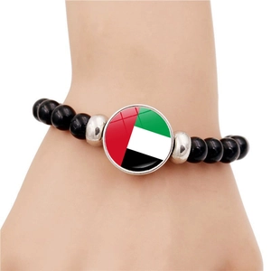 Ethnic style beaded bracelet featuring the UAE flag in a round glass dome pendant