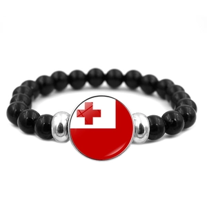 Detail of Tonga flag glass pendant on elastic bracelet with polished black beads
